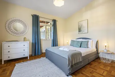 a bedroom with a bed and a dresser and a window at Quinta dos Landeiros - Prosa Verde by Homie in Machico