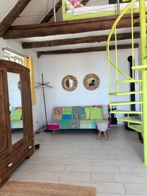 a living room with a couch and a staircase at Lucky Lemons Boutique Houses Madeira 1 in Calheta