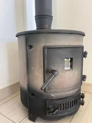 an old wood stove sitting on a wooden floor at Lucky Lemons Boutique Houses Madeira 1 in Calheta