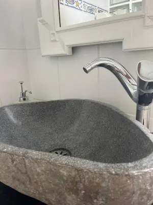 a granite sink with a faucet in a bathroom at Lucky Lemons Boutique Houses Madeira 1 in Calheta