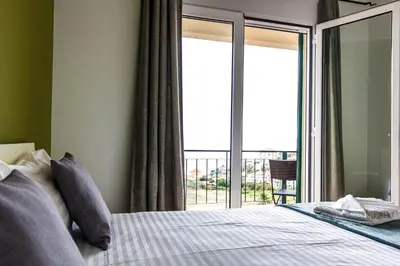 a bedroom with a bed and a balcony at Apartamento Bartolomeu By Horizon View Madeira in Caniço