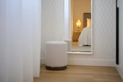 a view of a room with a mirror and a bed at Panoramic Pearl by Homie in Funchal