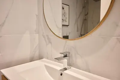 a bathroom with a white sink and a mirror at Panoramic Pearl by Homie in Funchal