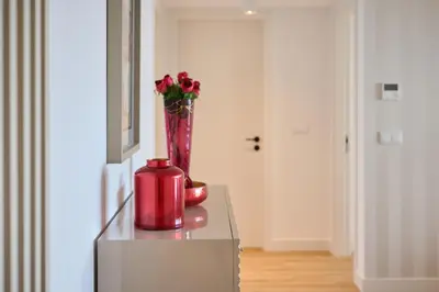a red vase with flowers on top of a table at Panoramic Pearl by Homie in Funchal