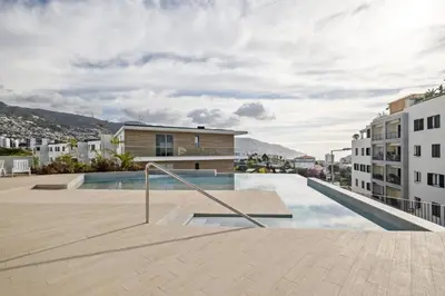 a swimming pool in the middle of a city with buildings at Panoramic Pearl by Homie in Funchal