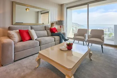 a woman sitting on a couch in a living room at Panoramic Pearl by Homie in Funchal