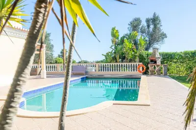 a swimming pool in a yard with a fence at Lote 50 at Boavista Resort Lagos in Lagos