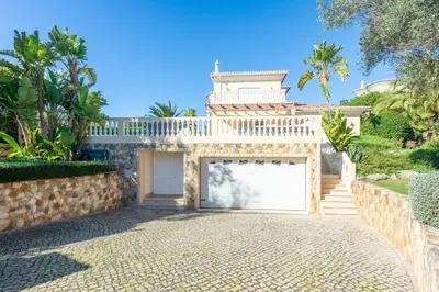 a house with a garage and a fence at Lote 50 at Boavista Resort Lagos in Lagos