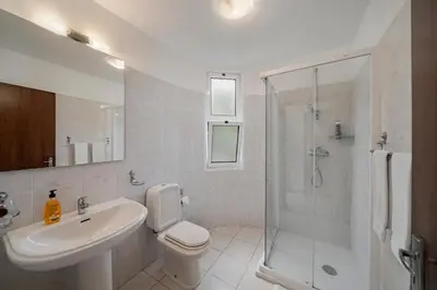 a bathroom with a sink toilet and a shower at Villa Amelia in Caniço