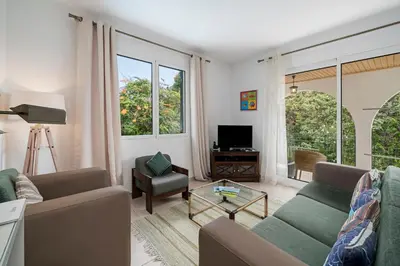 a living room with a couch and a table at Villa Amelia in Caniço