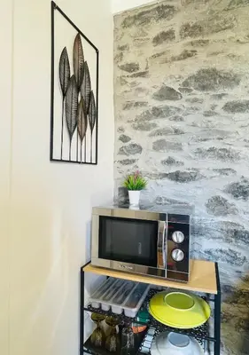 a microwave on a table in a room at Cozy House in Funchal