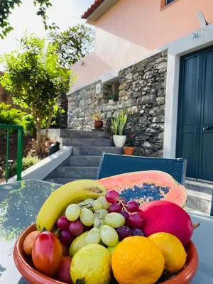 a bowl of fruit sitting on a table at Cozy House in Funchal