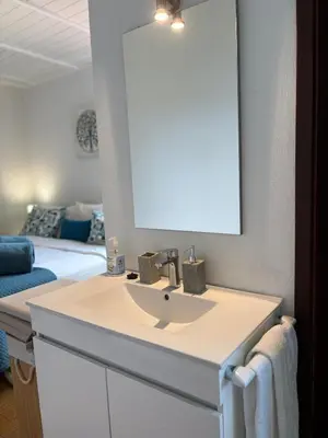 a bathroom with a toilet and a sink and a shower at Villa Alta Vista in São Jorge
