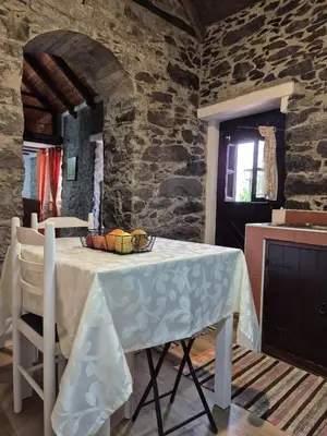 a table with a white table cloth on it in a kitchen at Casa Rosa in Camacha