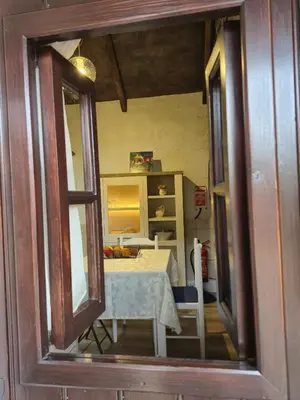 a view of a room with a table and a mirror at Casa Rosa in Camacha