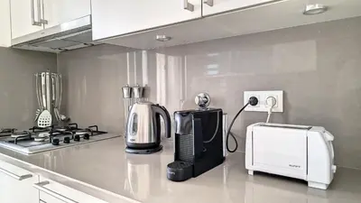 a kitchen with a coffee maker and a microwave at Sunset Bay by LovelyStay in Funchal
