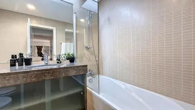 a bathroom with a shower and a sink and a tub at Sunset Bay by LovelyStay in Funchal
