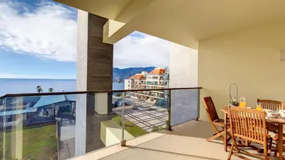 a balcony with a table and a view of the ocean at Sunset Bay by LovelyStay in Funchal
