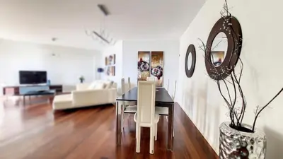 a dining room with a table and a couch at Sunset Bay by LovelyStay in Funchal