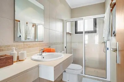 a bath tub with a faucet in a bathroom at 17 ° West, Lux. Inf. Pool villa, 5 minutes to the sandy beach, WiFi in Estreito da Calheta
