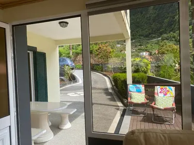 a balcony with a table and chairs and a view of a road at The Vista House in Ponta Delgada