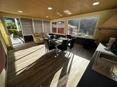 a kitchen with a table and chairs in a room at The Vista House in Ponta Delgada