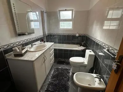 a bathroom with a sink and a toilet and a tub at The Vista House in Ponta Delgada