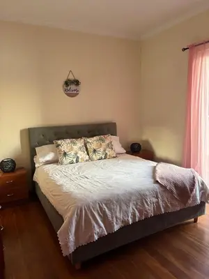 a bedroom with a large bed with white sheets at The Vista House in Ponta Delgada