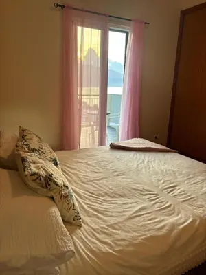 a white bed with a pillow and a window at The Vista House in Ponta Delgada