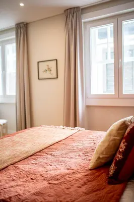 a bedroom with a large bed with a window at ISABELLA STUDIOS FUNCHAL in Funchal