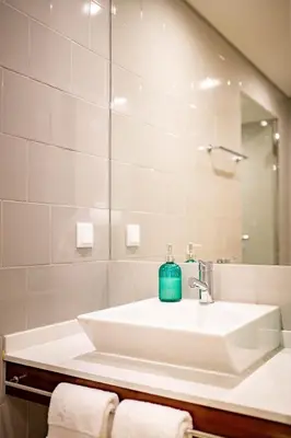 a bathroom with a sink and a mirror at ISABELLA STUDIOS FUNCHAL in Funchal