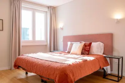 a bedroom with a large bed with a window at ISABELLA STUDIOS FUNCHAL in Funchal