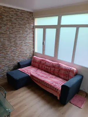 a couch in a room with a brick wall at House Luís Ornelas in Fajã do Mar