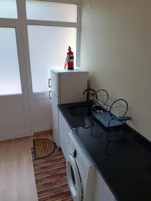 a kitchen with a sink and a dishwasher at House Luís Ornelas in Fajã do Mar