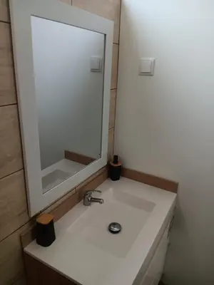 a bathroom with a white sink and a mirror at House Luís Ornelas in Fajã do Mar