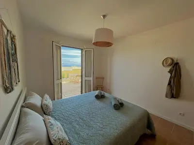 a bedroom with a bed and a window with a view at Porto Santo Happy Place in Porto Santo