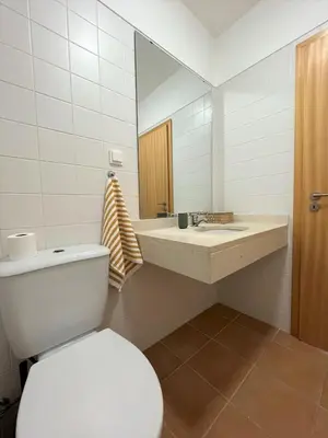 a bathroom with a toilet and a sink and a mirror at Porto Santo Happy Place in Porto Santo