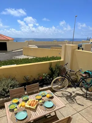 a table with plates of food on a patio at Porto Santo Happy Place in Porto Santo