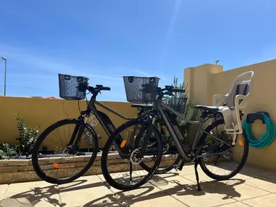 two bikes parked next to each other on a sidewalk at Porto Santo Happy Place in Porto Santo
