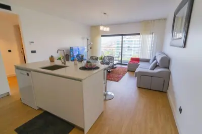 a bathroom with a sink and a toilet and a mirror at Apartamento Zona Turística in Funchal