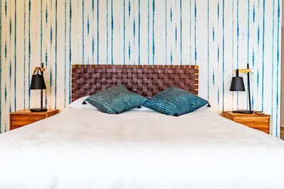 a bedroom with a bed and a chair and a window at One Sweet World in Calheta