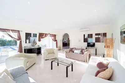 a living room with a couch and a table at Casa Ferrel - Luxury 9 Bedroom Villa with Indoor & Outdoor Pools in Lagos