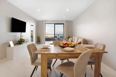a dining room with a wooden table with a bowl of fruit at Dream View in Funchal