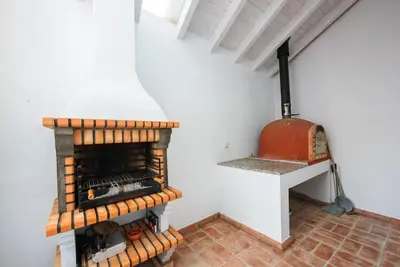 a room with a brick floor and an oven at Casa elegante em Vila tranquila in Barão de São Miguel