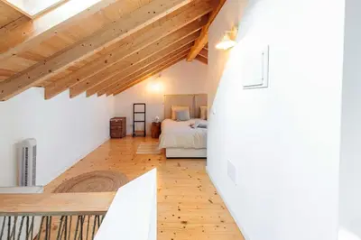 a bedroom with a bed in a room with wooden ceilings at Casa elegante em Vila tranquila in Barão de São Miguel