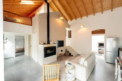 a living room with a couch and a fireplace at Casa elegante em Vila tranquila in Barão de São Miguel