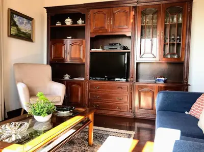 a living room with a large wooden entertainment center at Costa's OldTown House in Funchal in Funchal