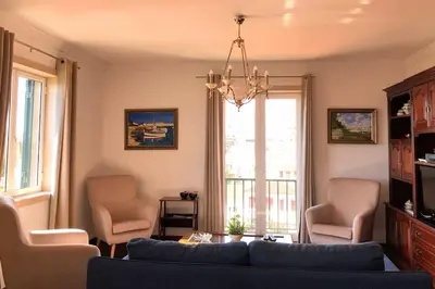 a living room with a blue couch and chairs at Costa's OldTown House in Funchal in Funchal
