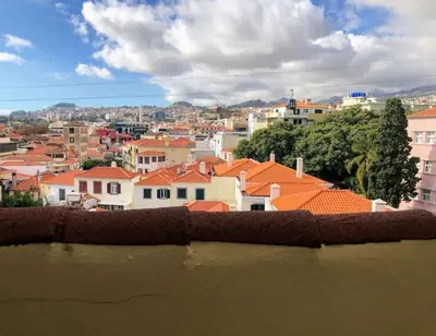 a view of a city with houses and roofs at Costa's OldTown House in Funchal in Funchal