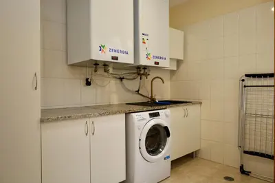 a kitchen with a washing machine in a kitchen at Quinta dos Cardais by AnaLodges in São Vicente